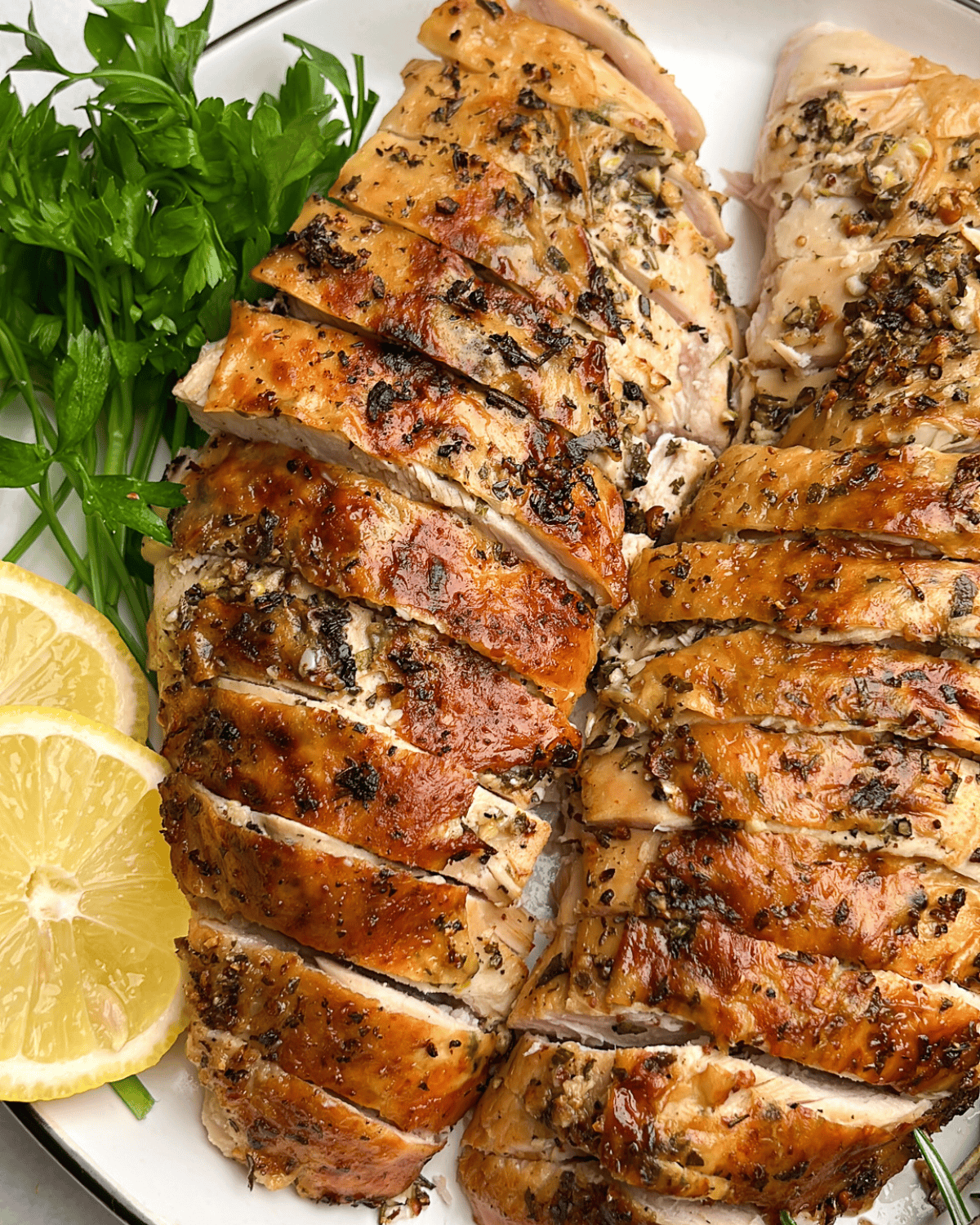 sliced garlic butter turkey on a plate
