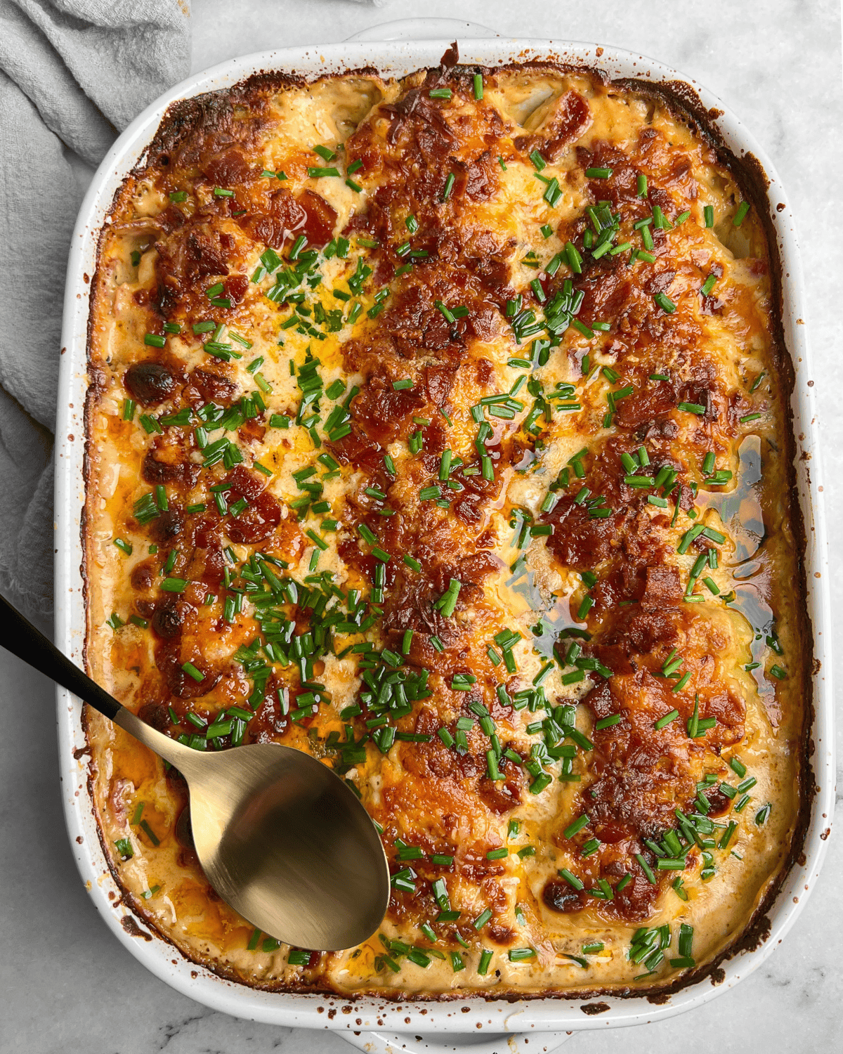 scalloped potatoes with cheese, bacon, and chives