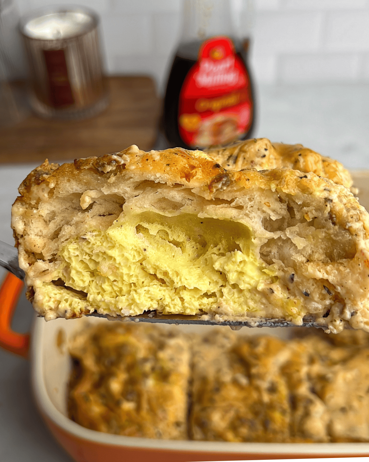 eggs and biscuits layered with sausage in biscuits and gravy casserole