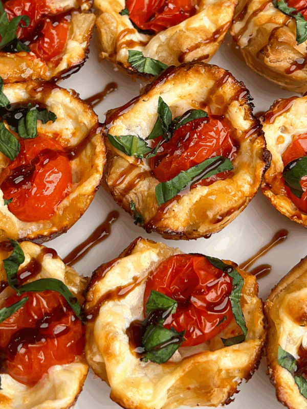 Overhead close up of baked caprese bites drizzled with balsamic glaze