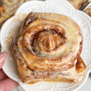 orange cinnamon roll on a dessert plate