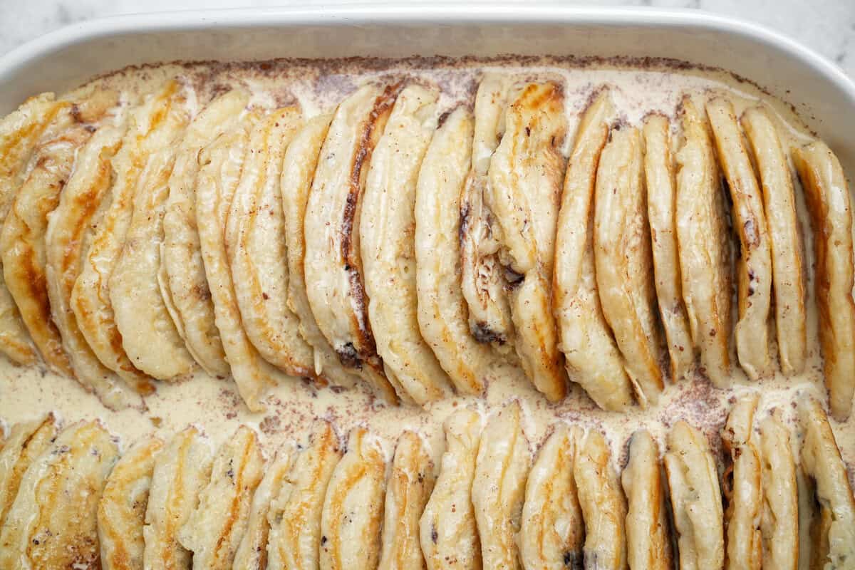 This overnight Pancake Casserole is cozy, decadent, and perfect for slow weekend mornings or holiday brunch. Super easy to make! Pancake casserole with the custard filling poured over