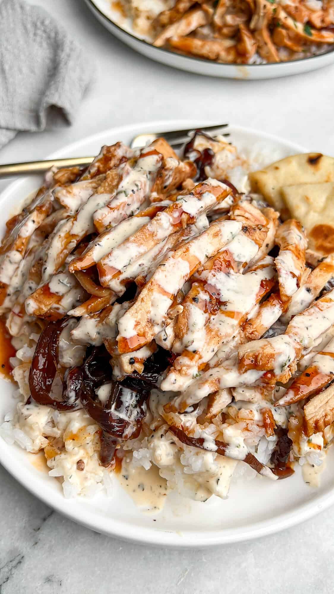 a plate full of bbq chicken and rice