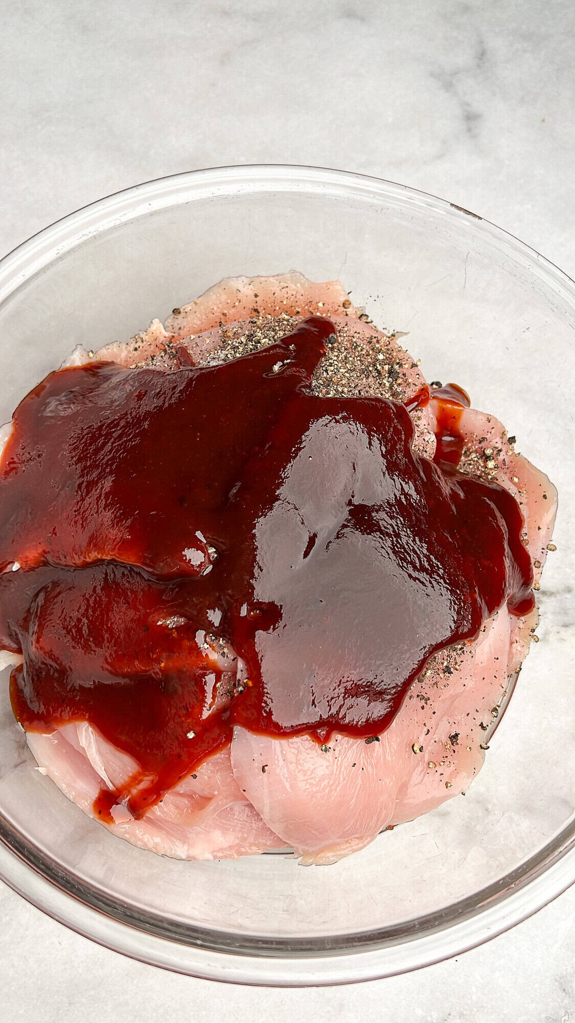 seasoning and barbecue sauce sitting in a bowl with chicken