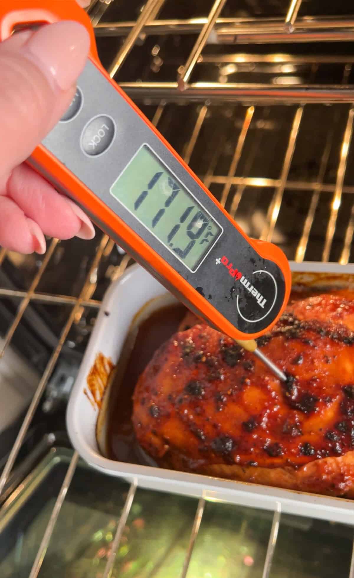a meat thermometer inserted into the chicken loaf pan