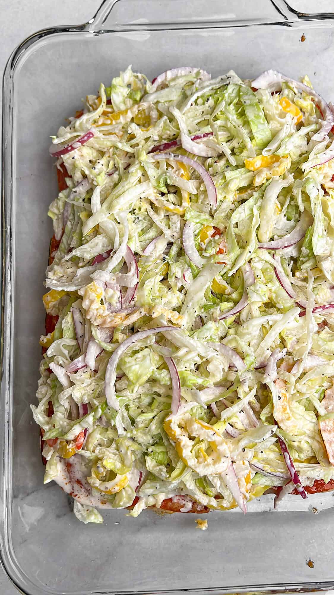 piling the dressing-coated veggies onto the warm sliders