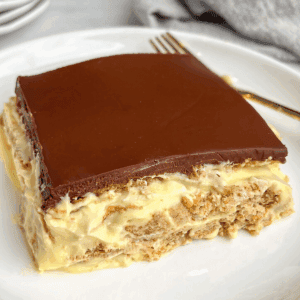 featured image of a slice of no bake eclair cake sitting on a plate