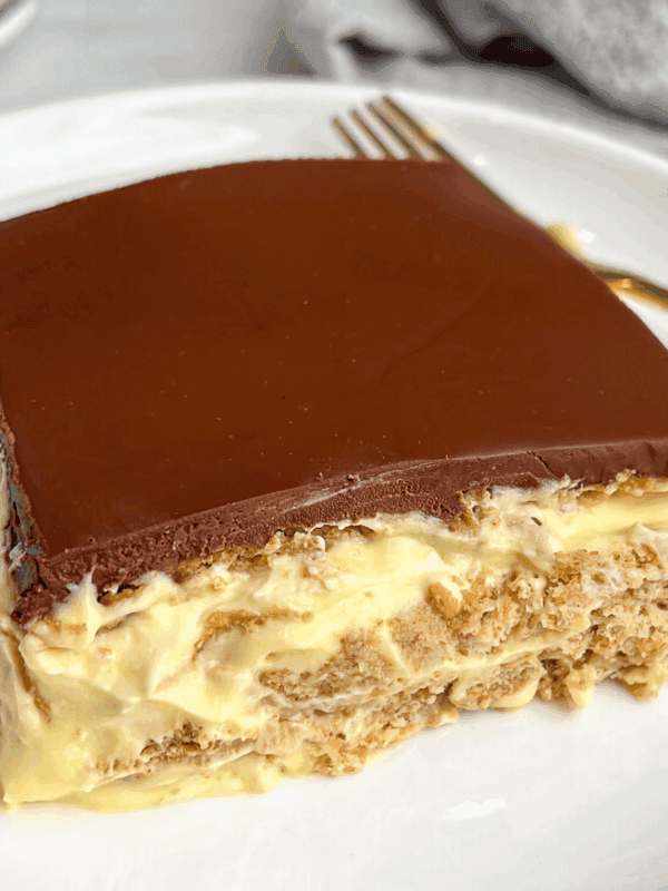 featured image of a slice of no bake eclair cake sitting on a plate
