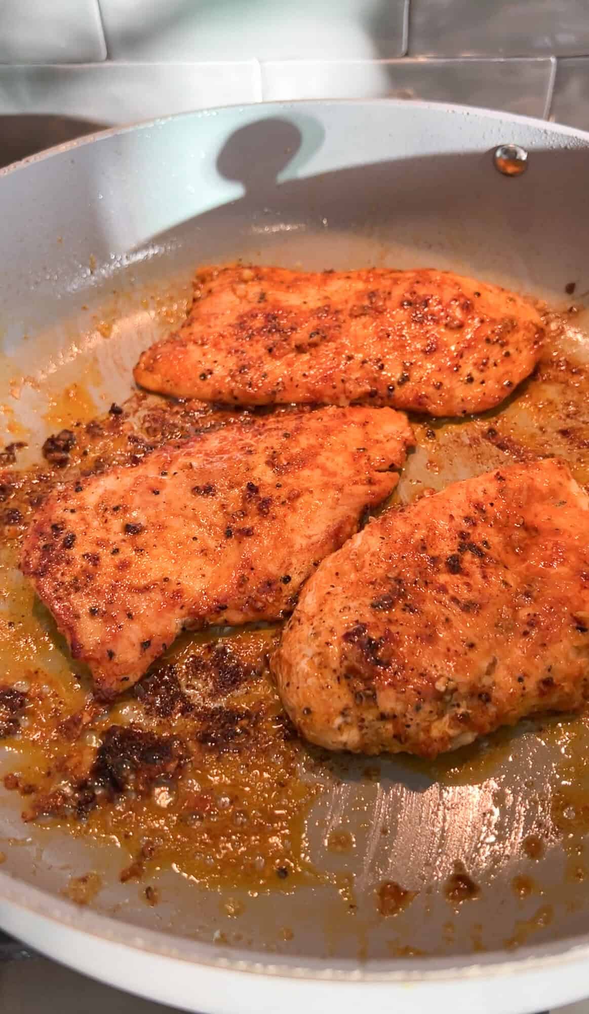chicken being sautéd in a pan