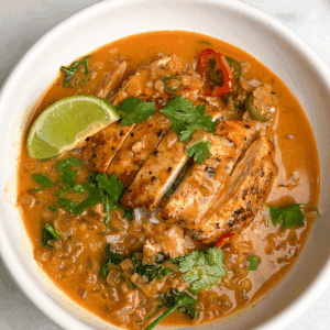 bowl of thai coconut brothy rice with a lime wedge on top