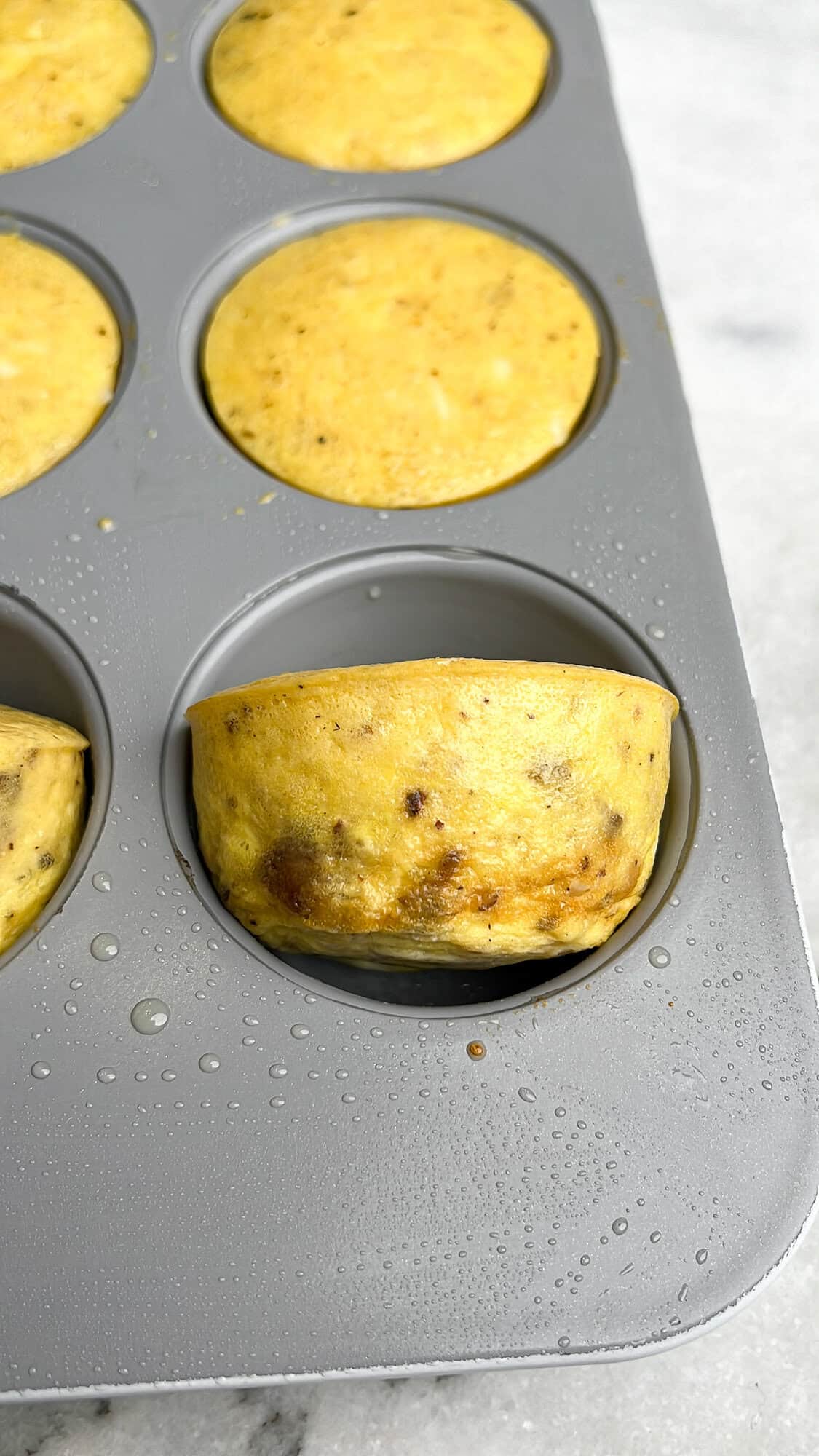 cooked truffle and brie egg bites in a pan