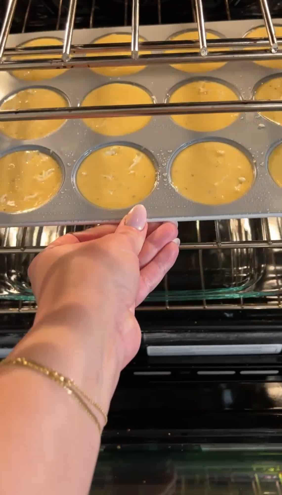placing truffle and brie egg bites in the oven
