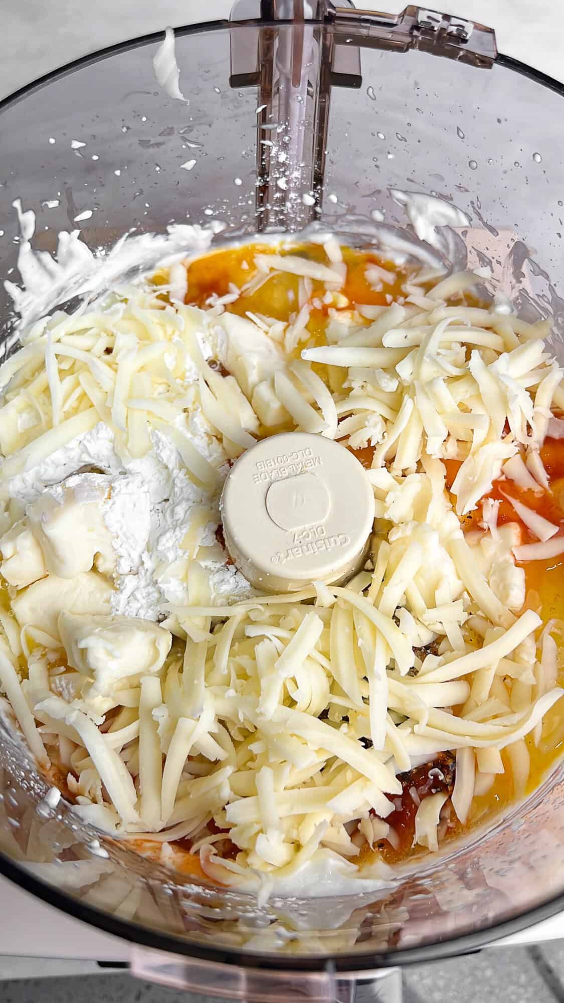 egg mixture in a food processor with cheese added