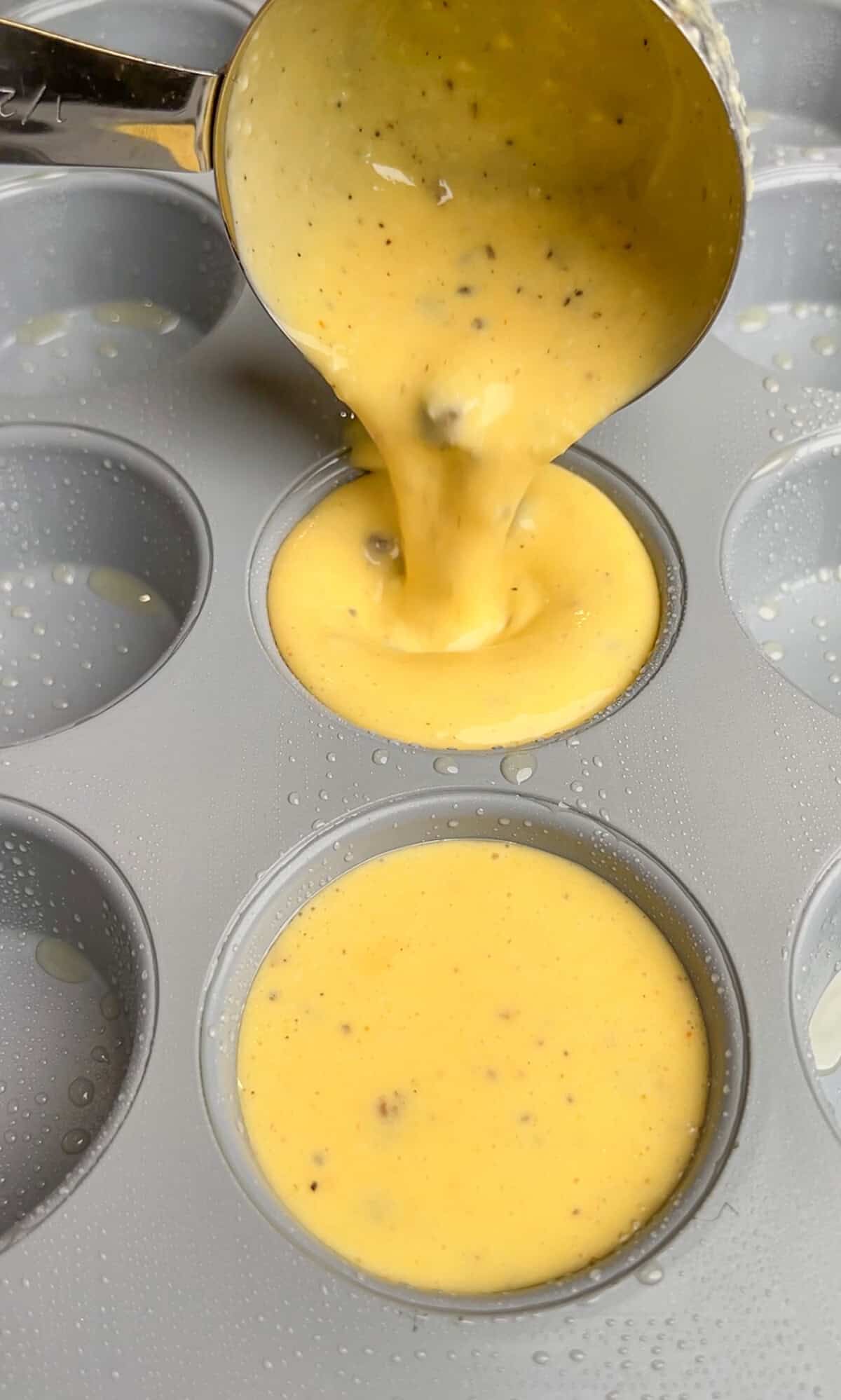 filling the muffin cups with the egg mixture