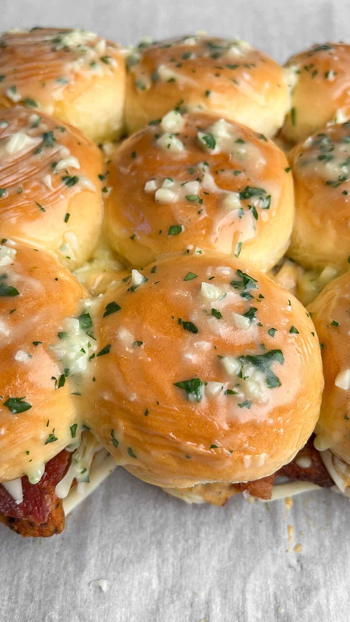 Tops of slider buns brushed with garlic butter