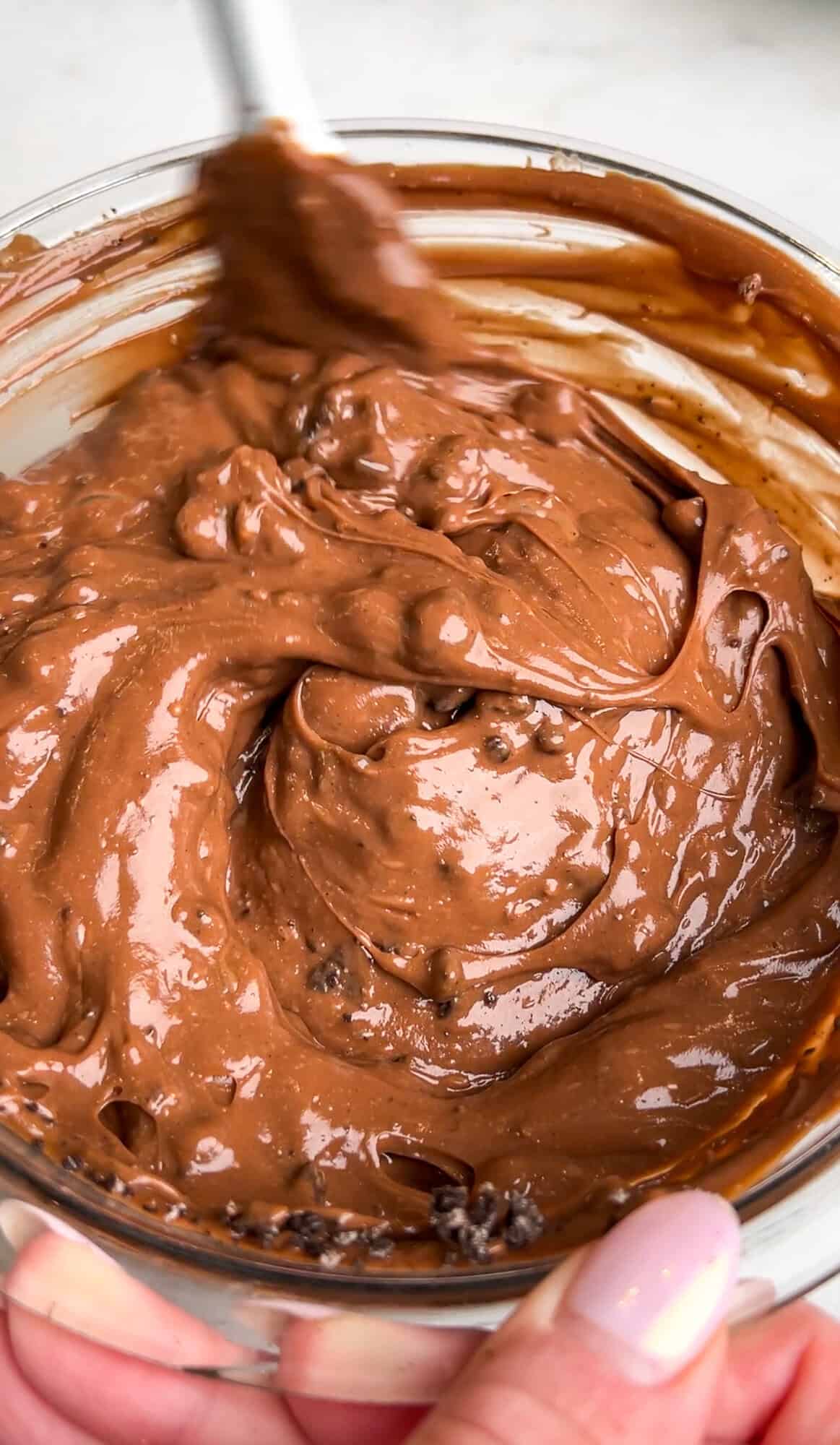 Stirring the oreos into the chocolate pudding