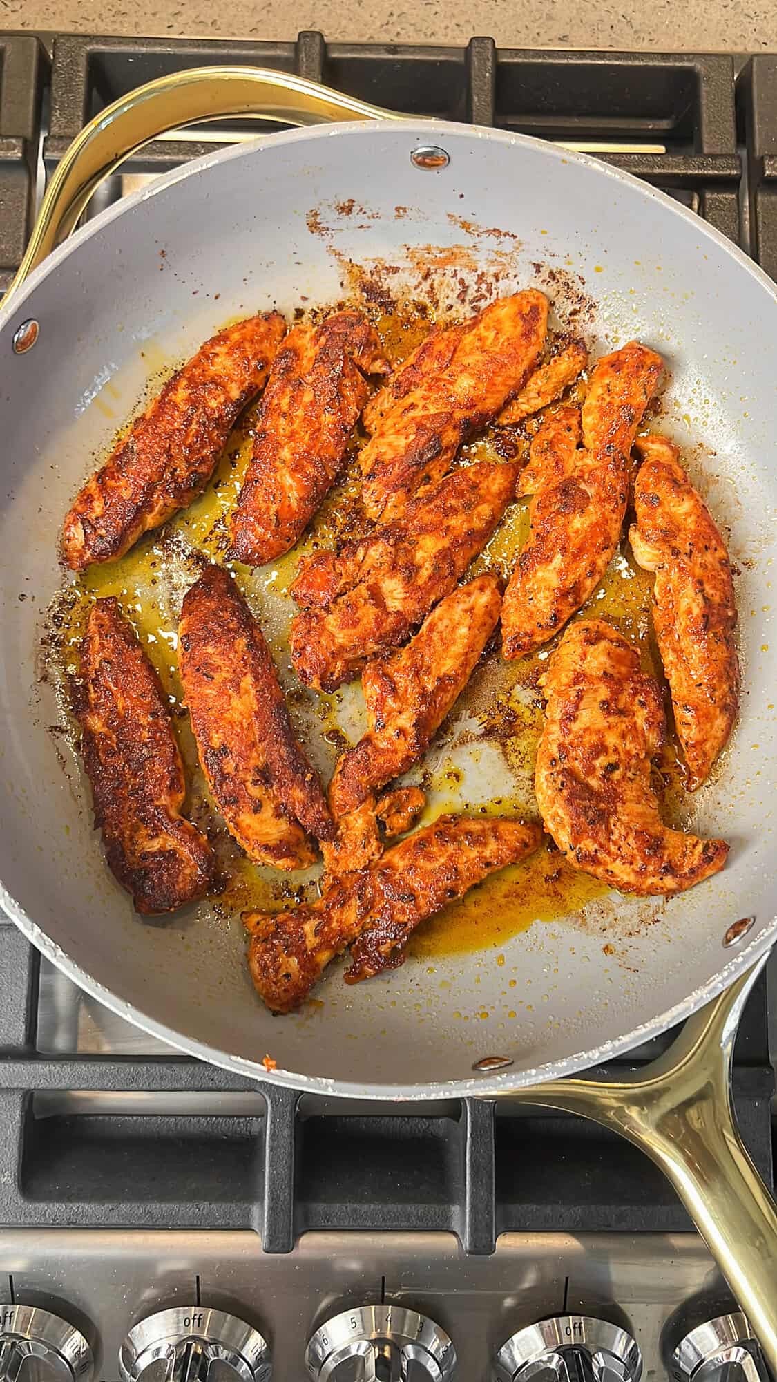 blackened chicken tenderloins cooking in a pan
