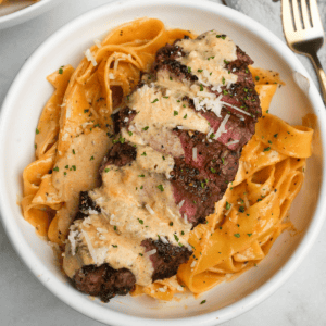 creamy pasta with steak in a bowl