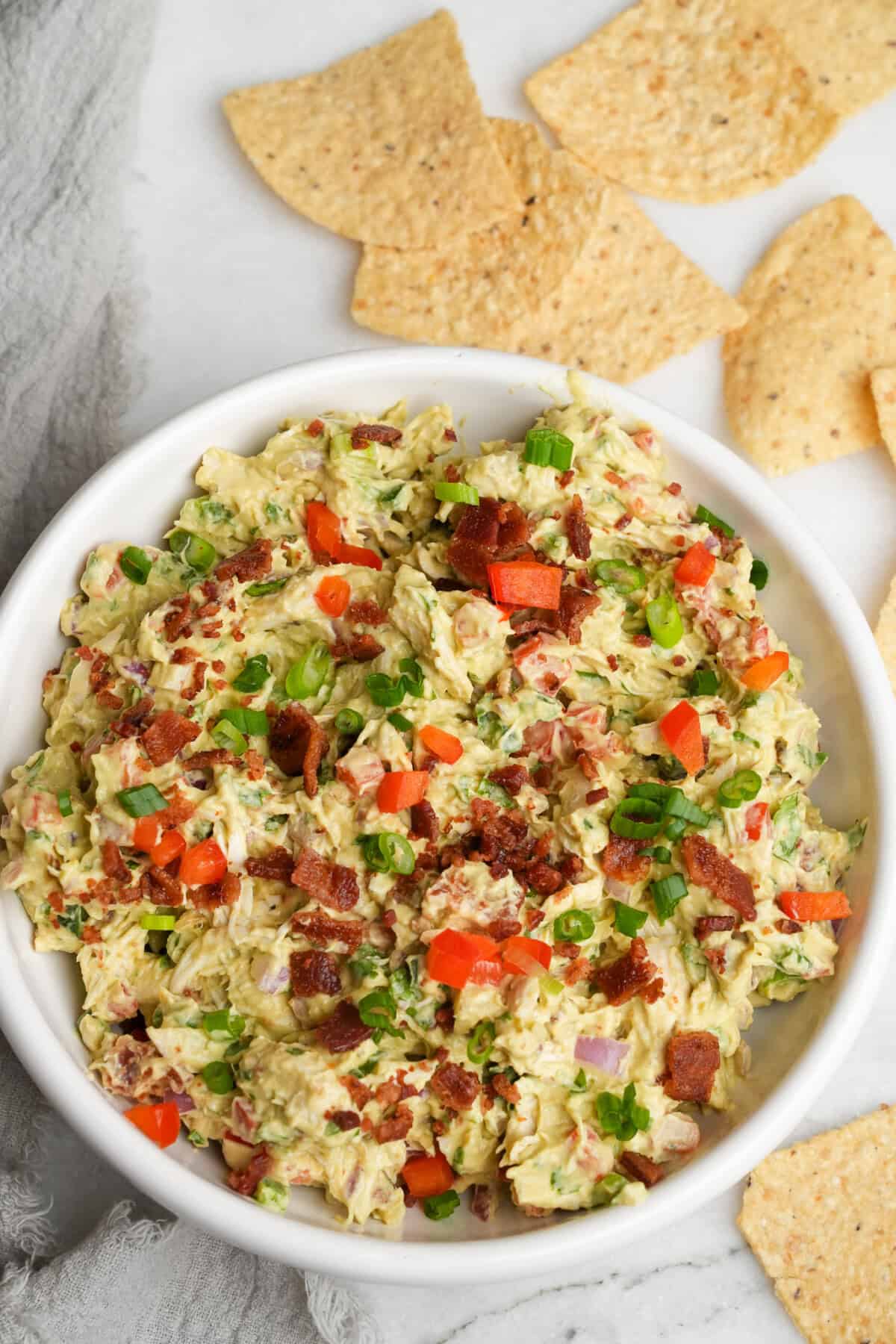 guacamole chicken salad in a bowl with tortilla chips