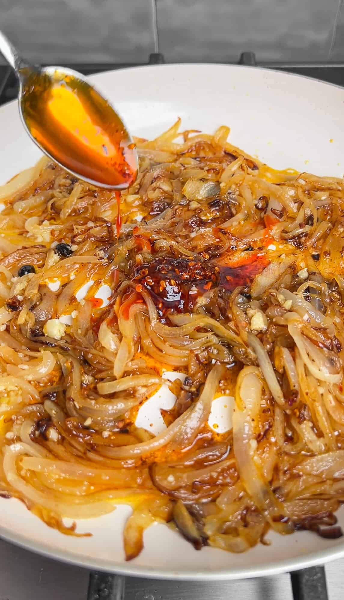 chili oil adding to caramelized onions