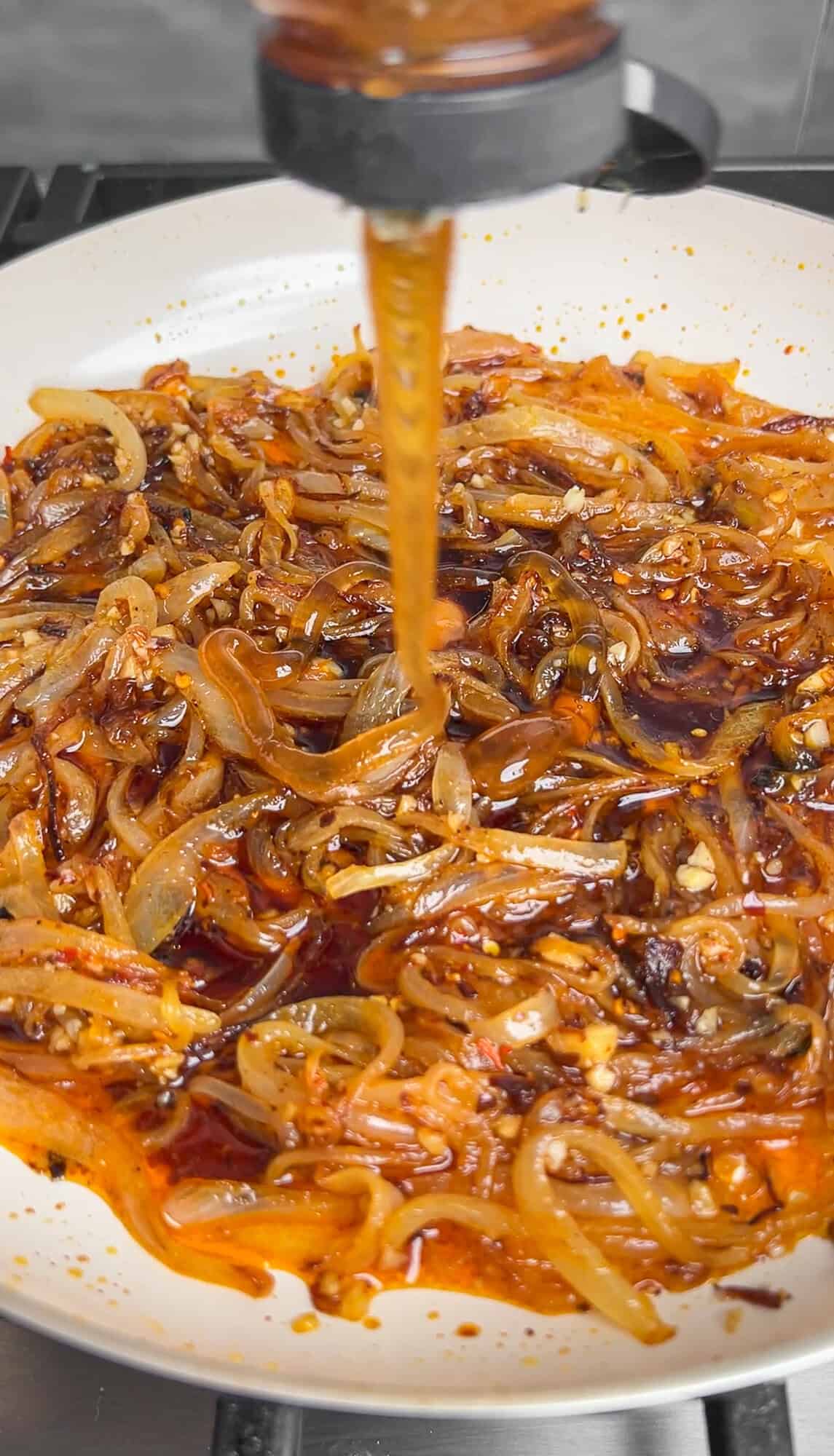 adding honey and soy sauce into the caramelized onion pasta sauce