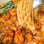 shrimp scampi being tossed in a pot
