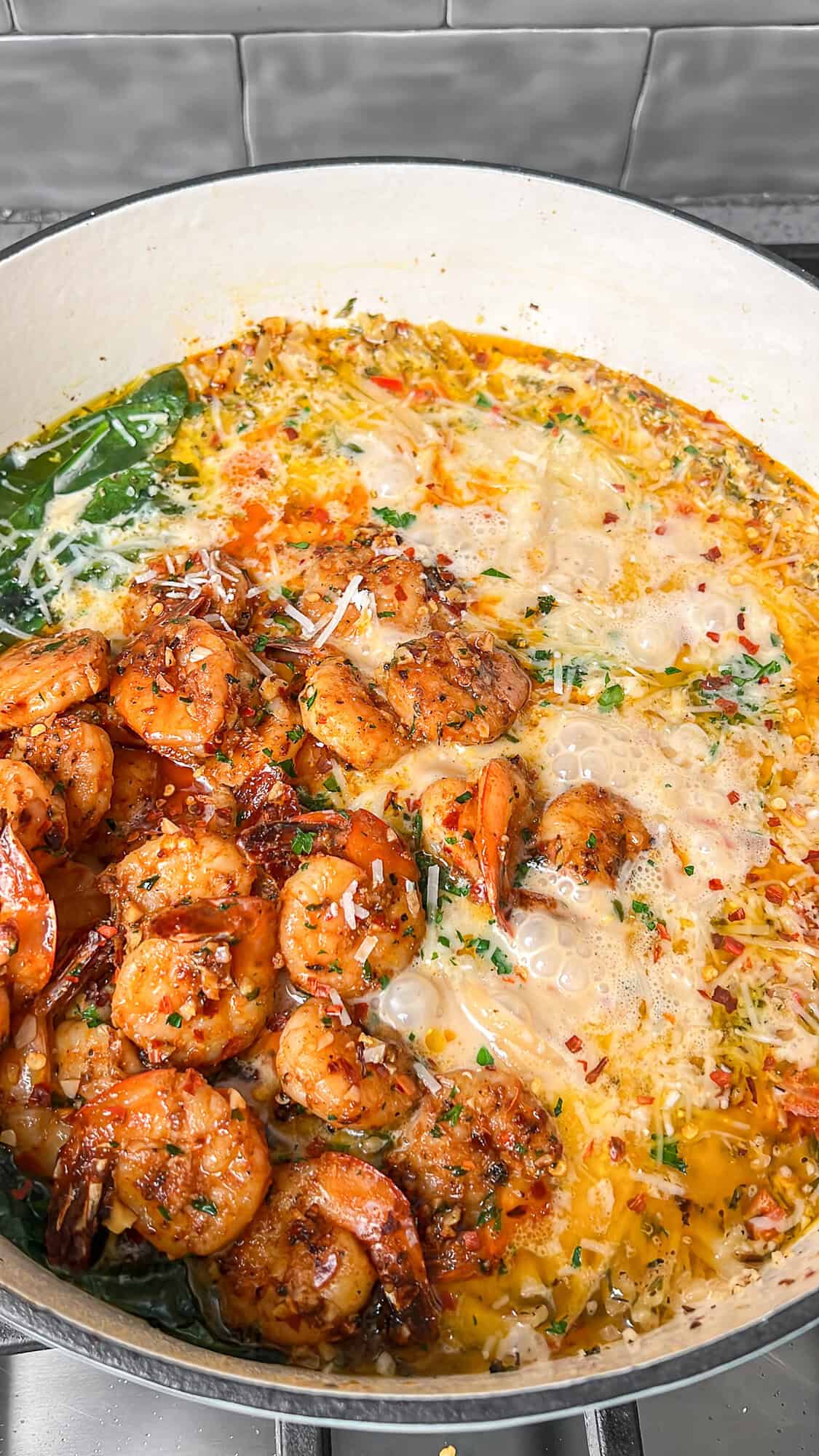 adding the shrimp back into the pot for shrimp scampi