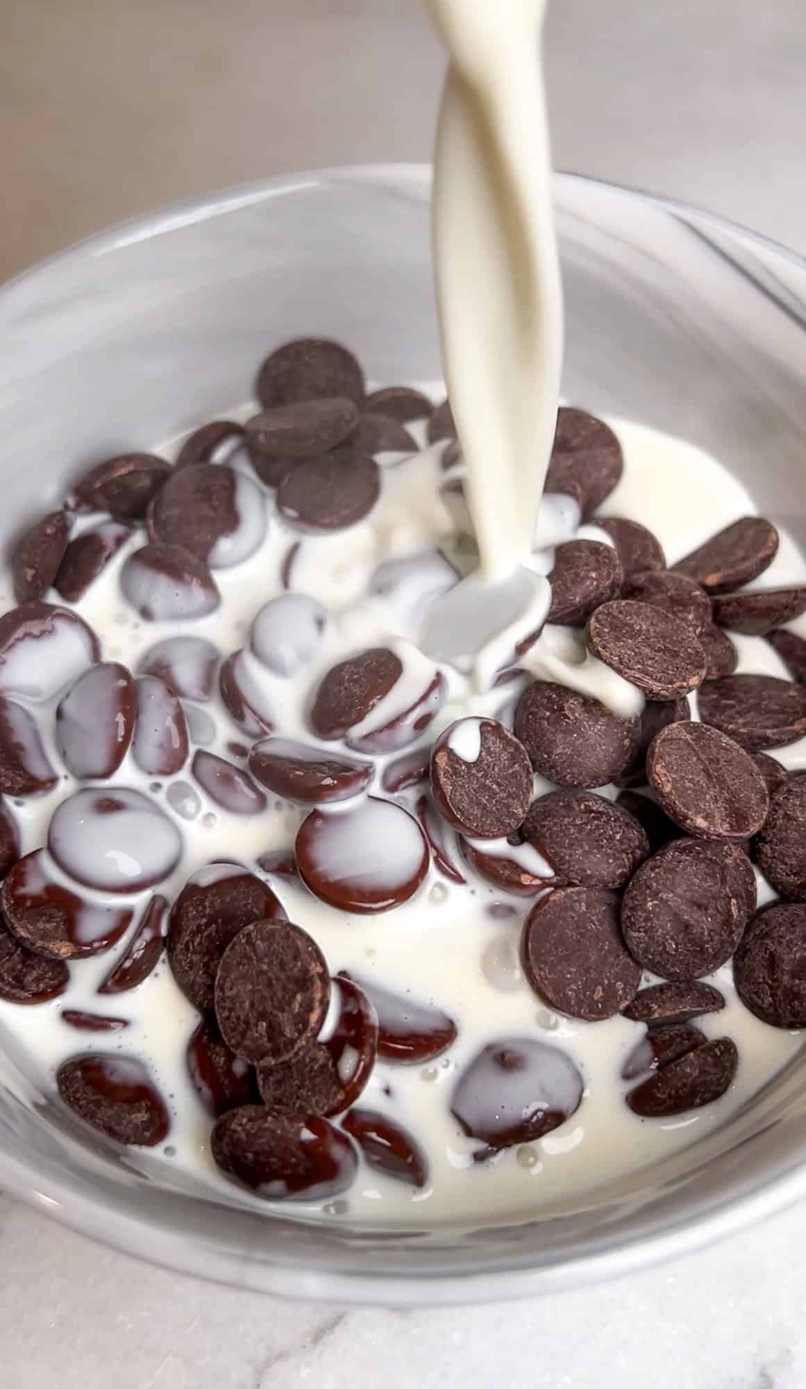 pouring warm cream over the chocolate