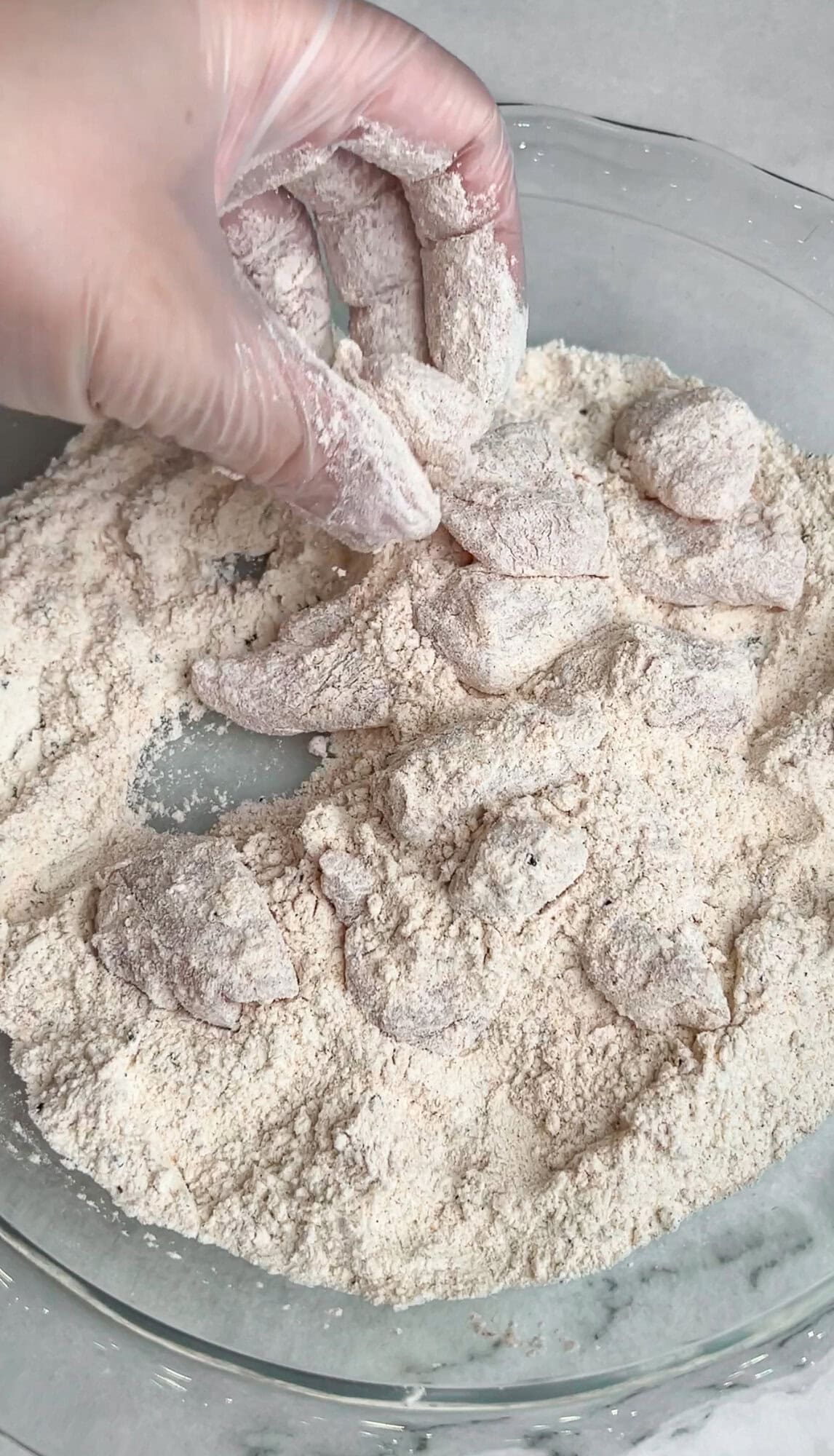 Dredging the chicken in flour