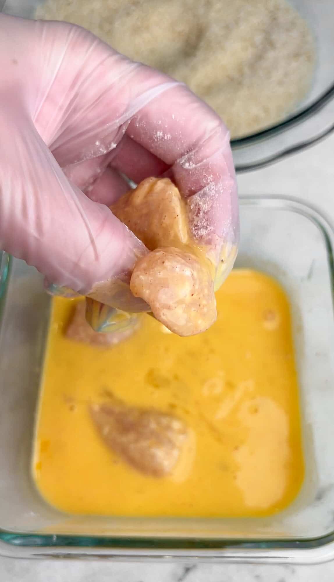 tossing the chicken in egg wash