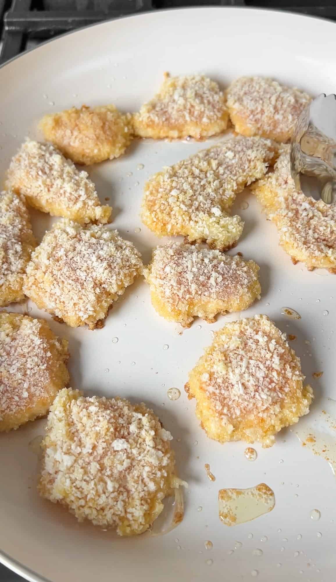 cooking the panko chicken in a pan