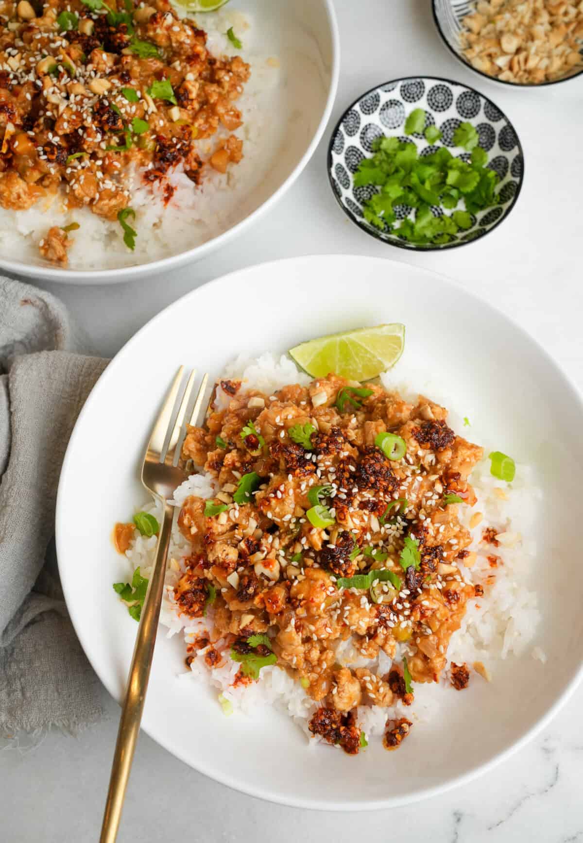 a bowl of ground chicken and rice with chili oil