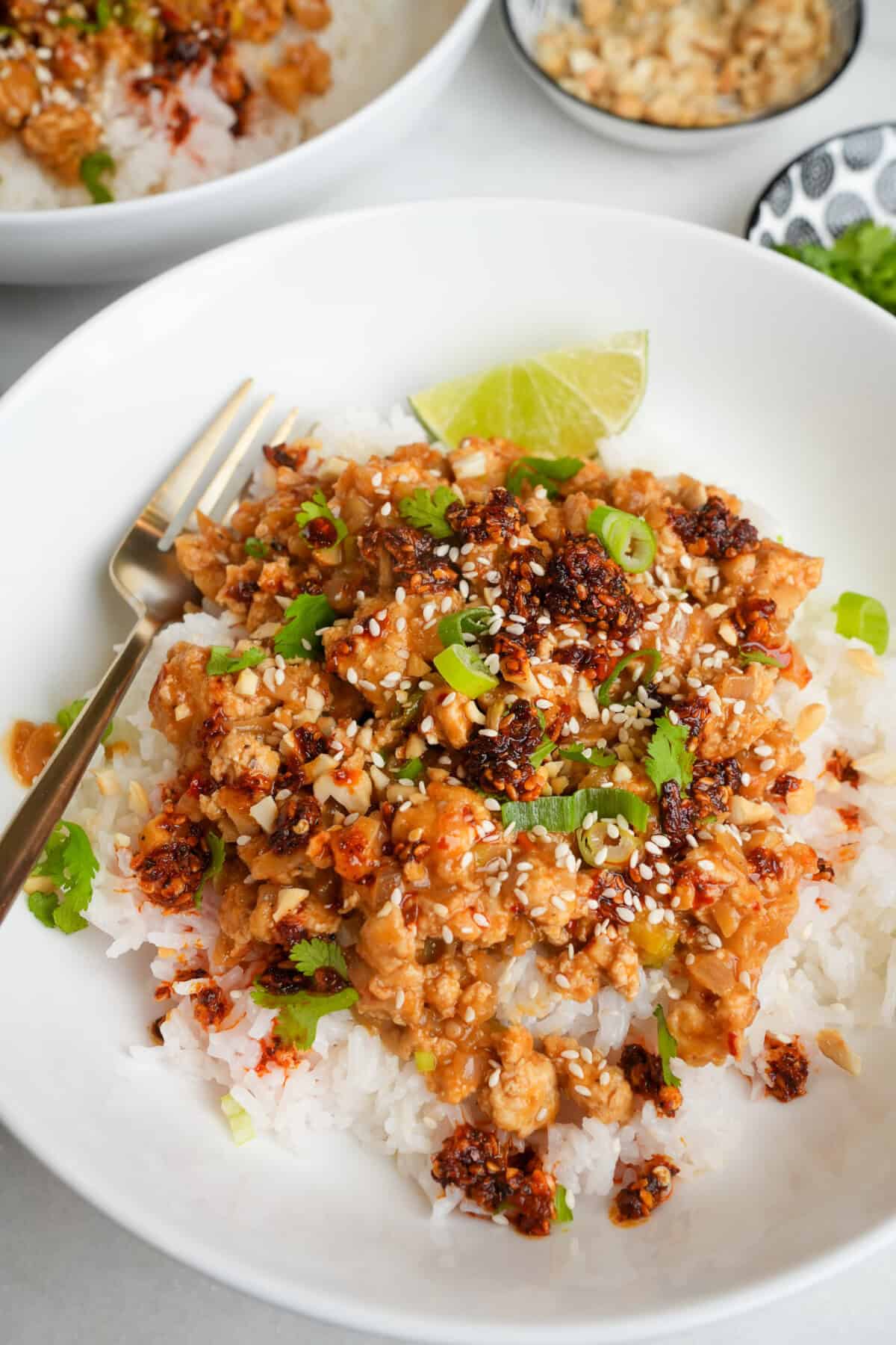 a bowl of ground chicken and rice with chili oil