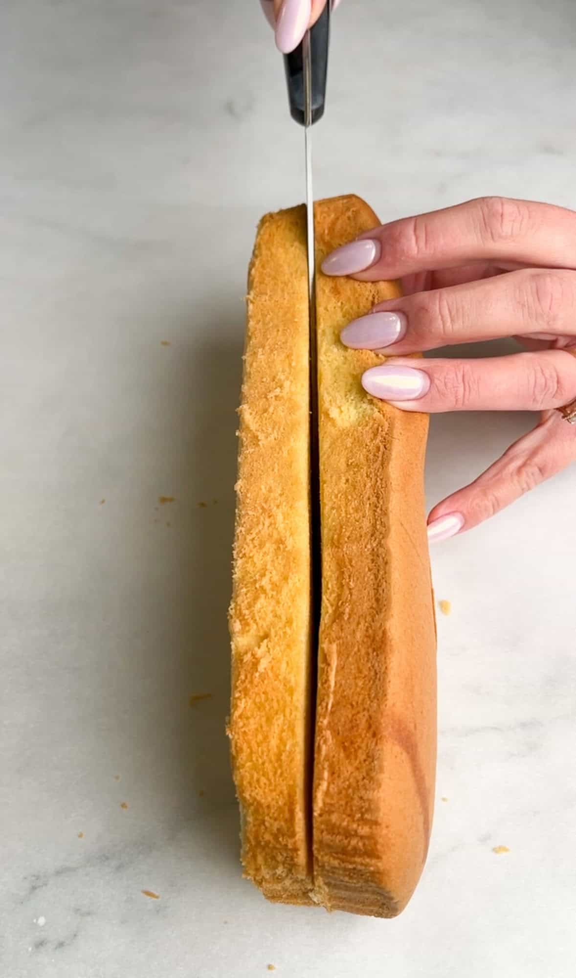 slicing a pound cake in half horizontally