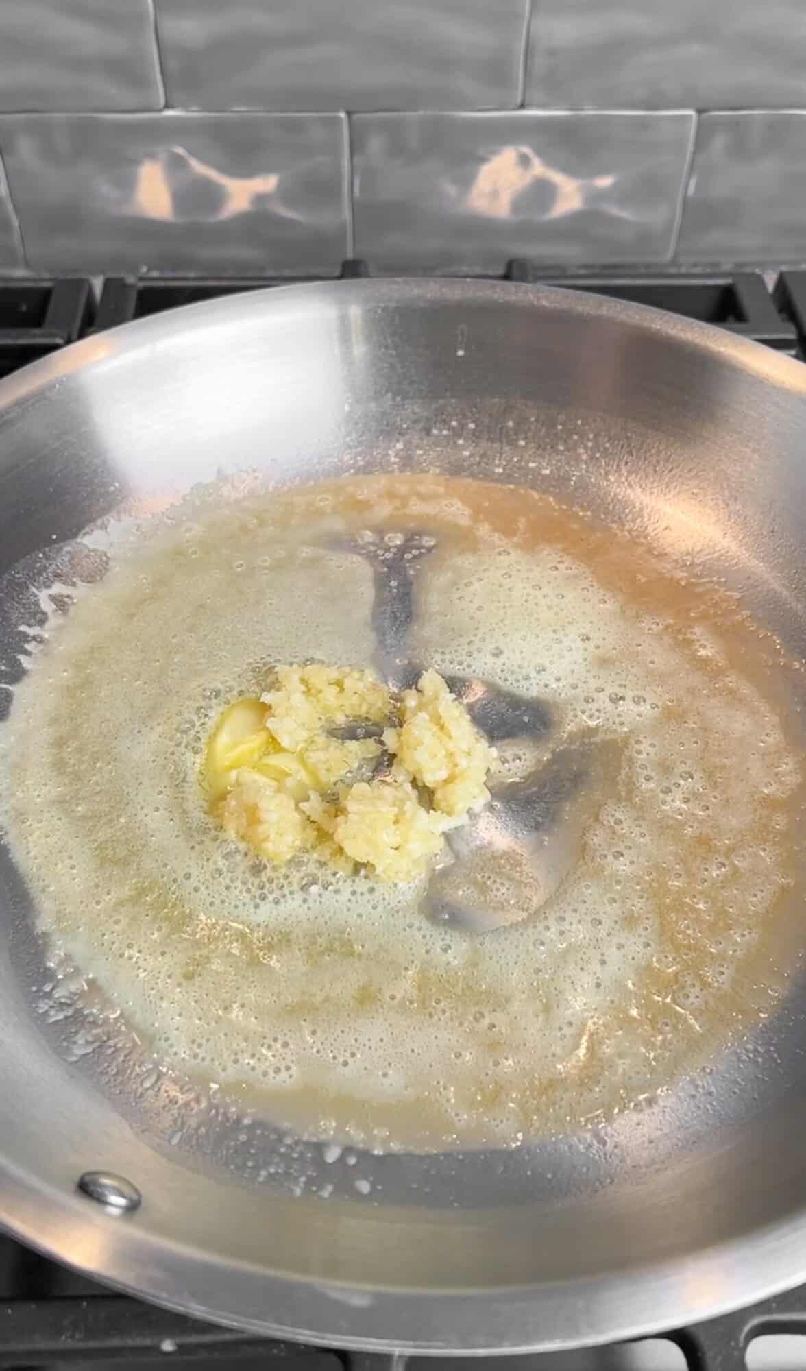 sautéing garlic in butter for creamy lemon pasta