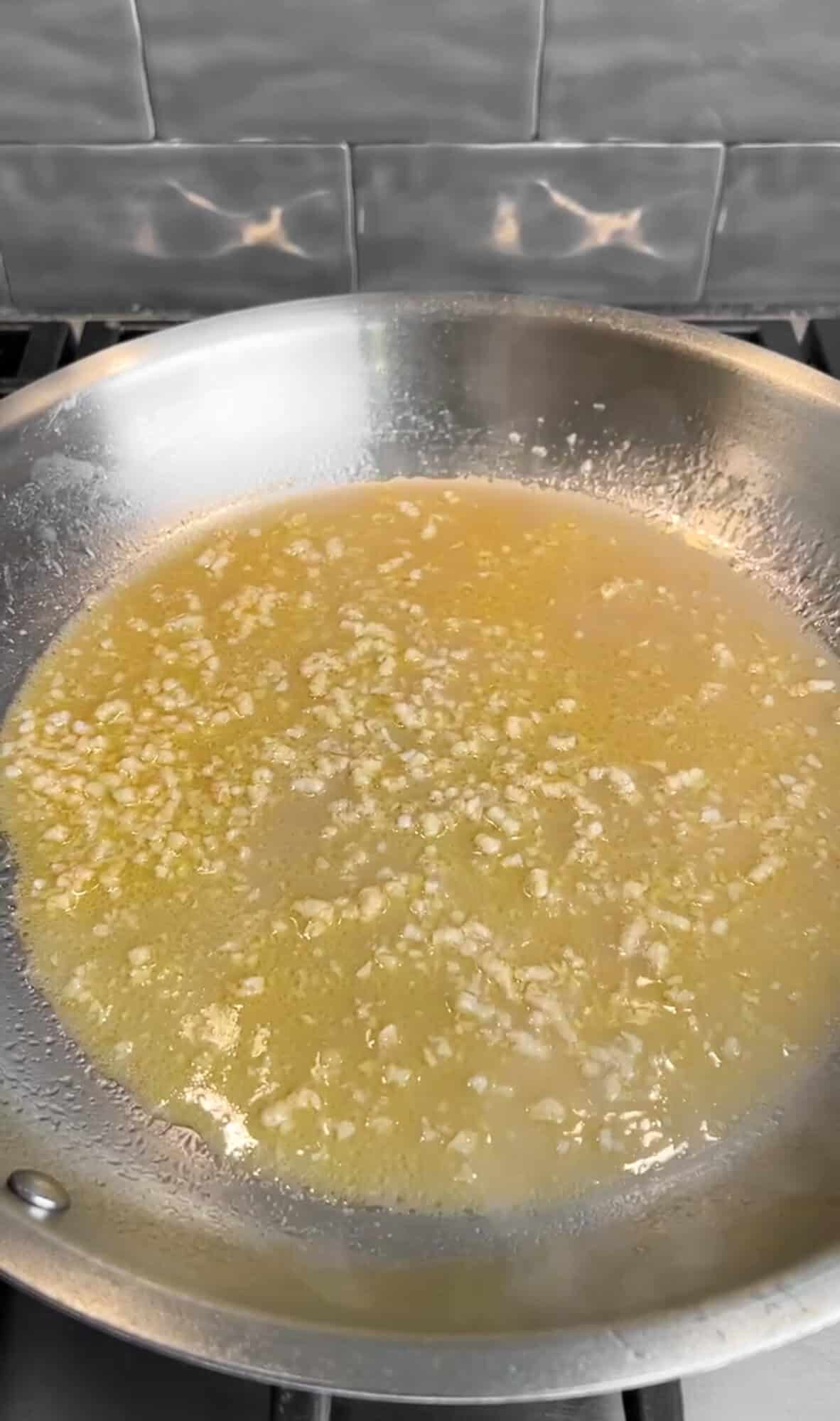 reducing the wine for creamy lemon pasta