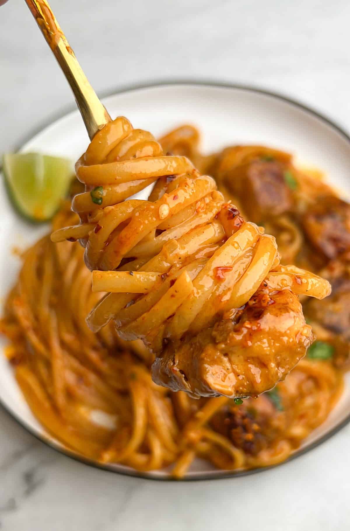 chili oil noodles twirled around a fork