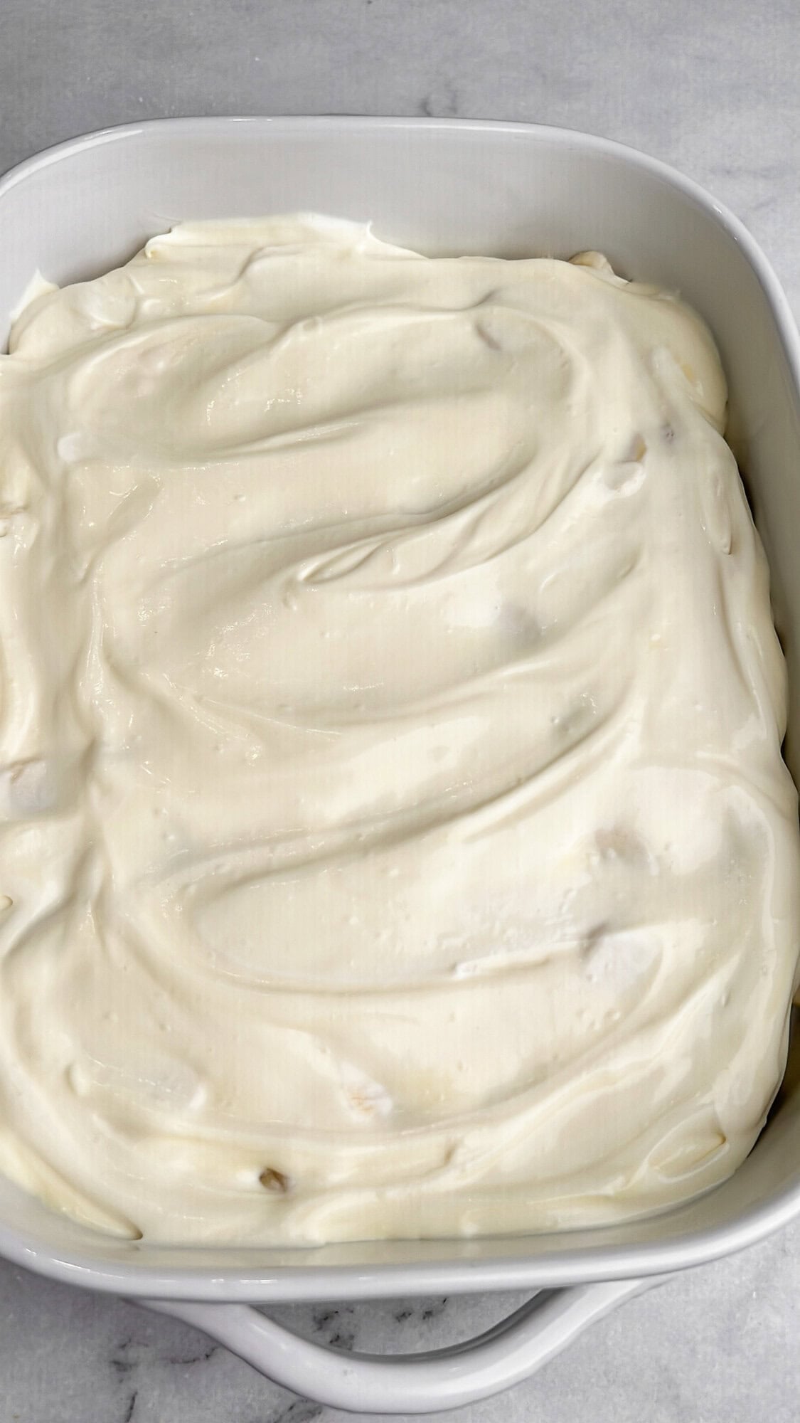 a layer of creamy banana pudding in a pan
