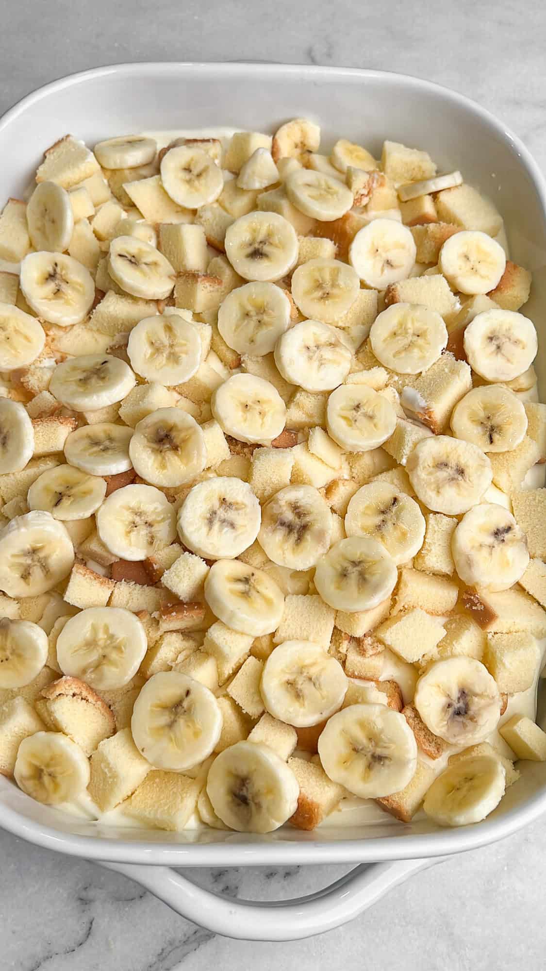 a second layer of bananas and pound cake in a pan