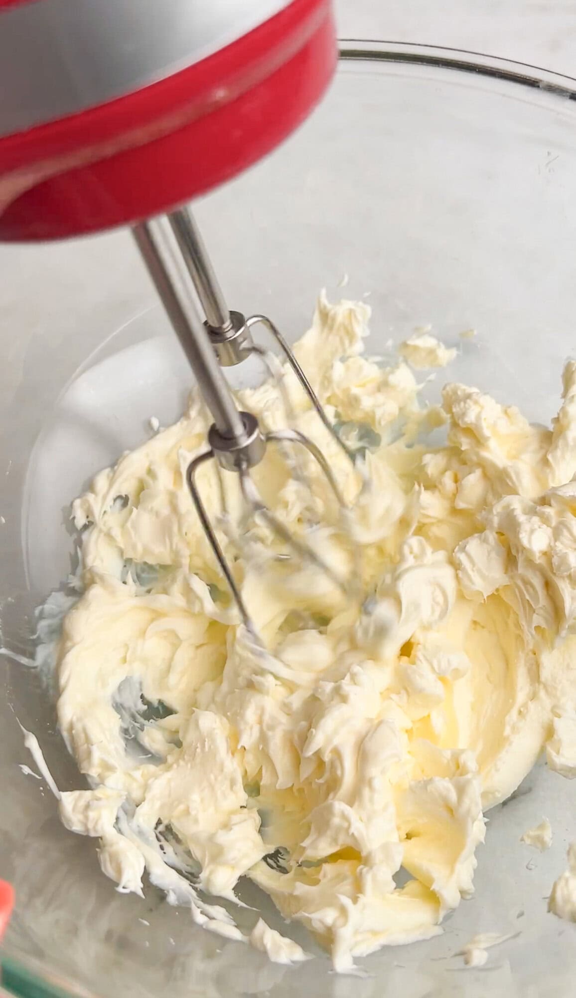 blending cream cheese in a bowl