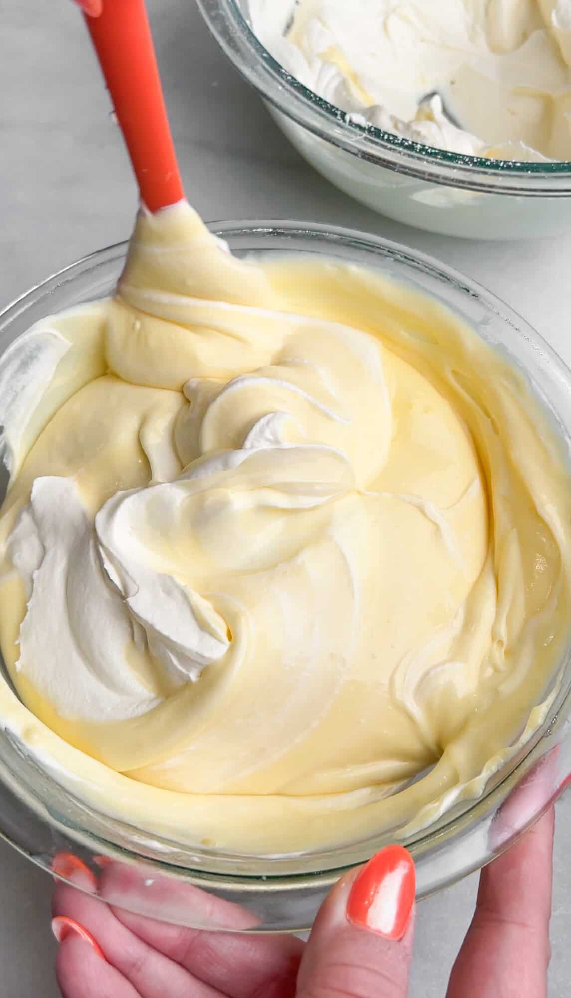 folding whipped cream into vanilla pudding