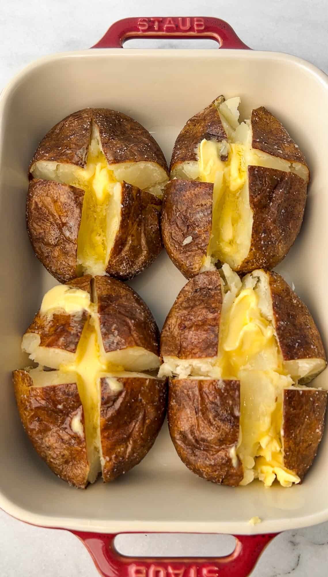 layering butter into the baked potatoes