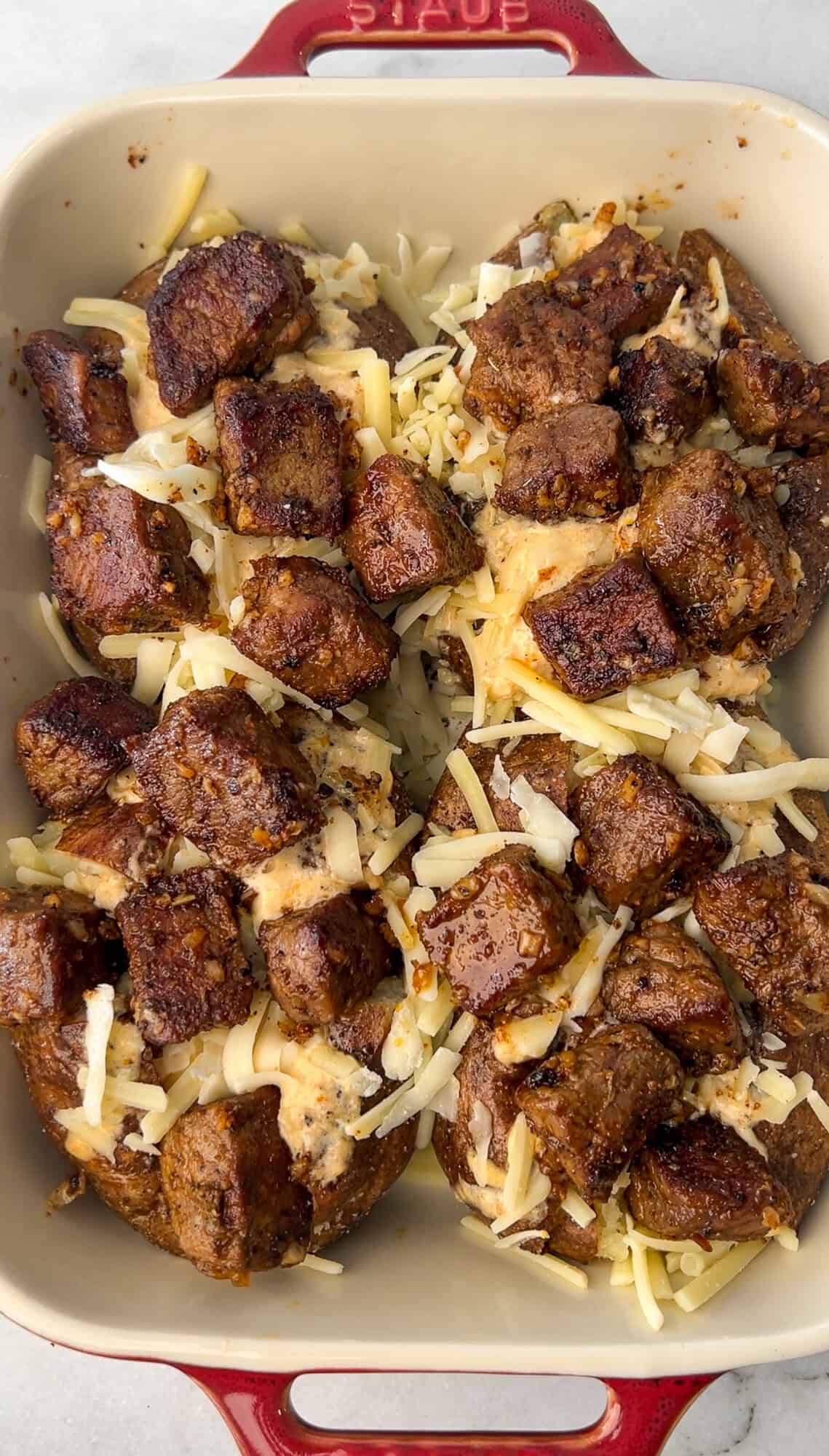 adding steak to the potatoes