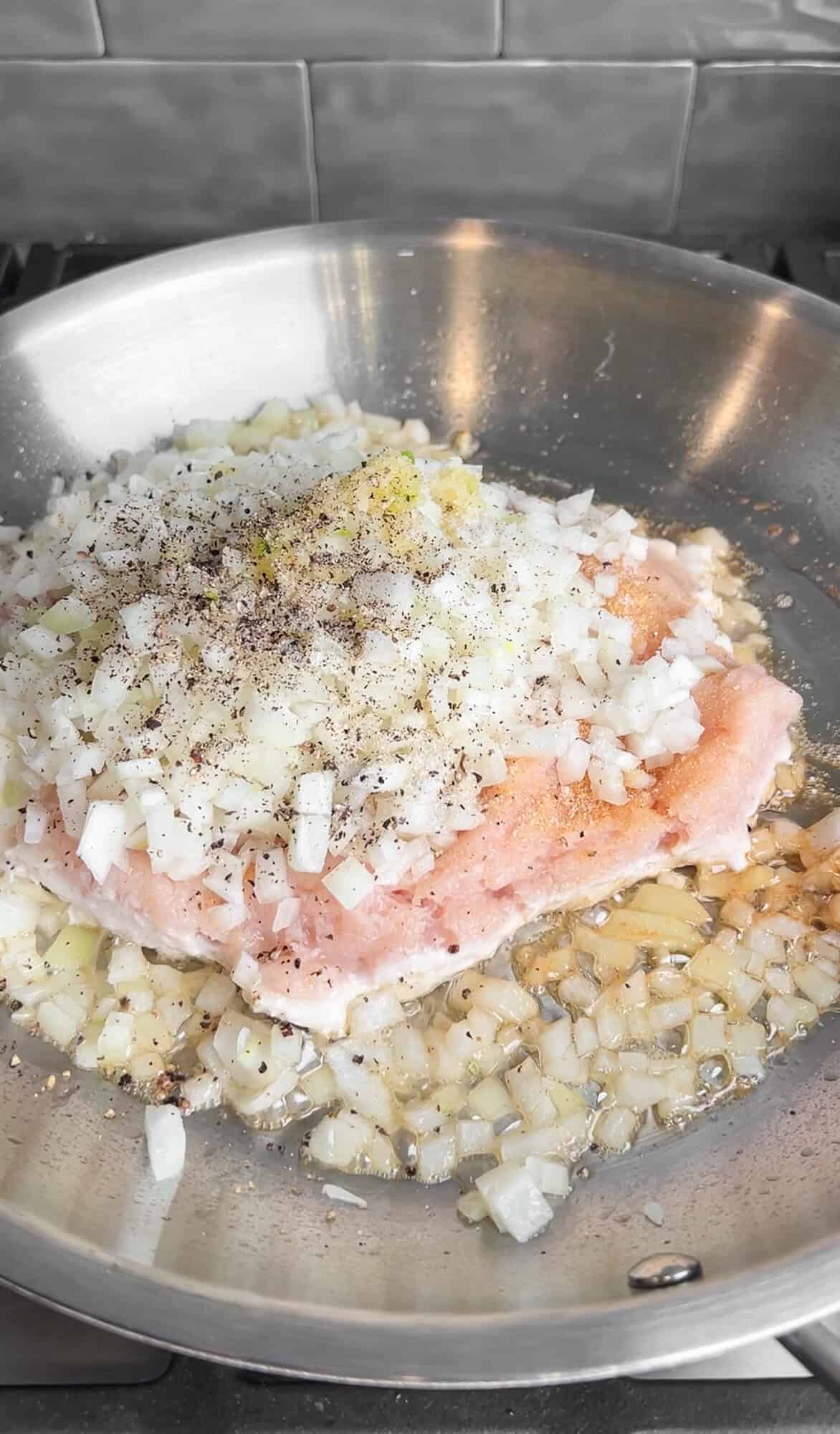 ground chicken with oinions and garlic in a pan