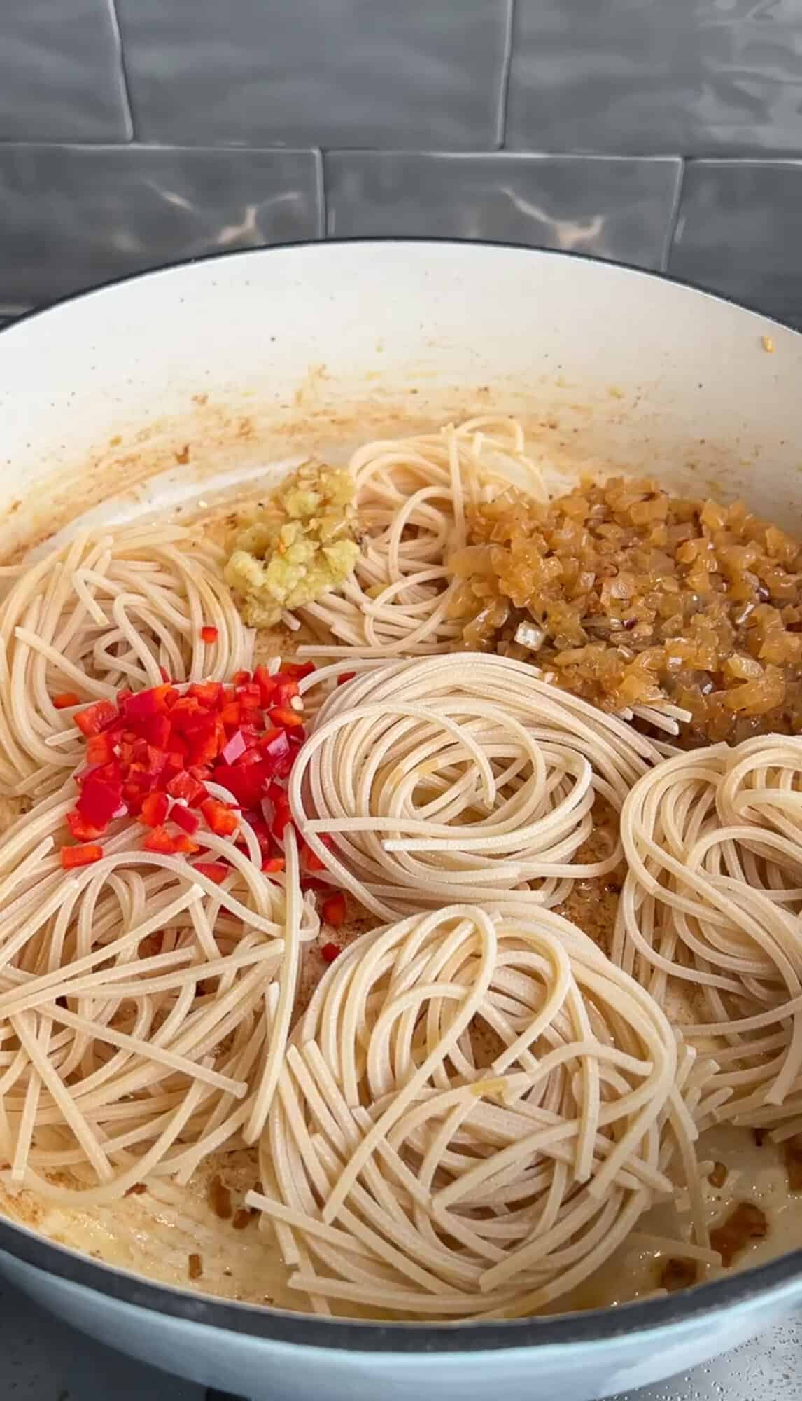 adding ingredients into pot for chicken scampi