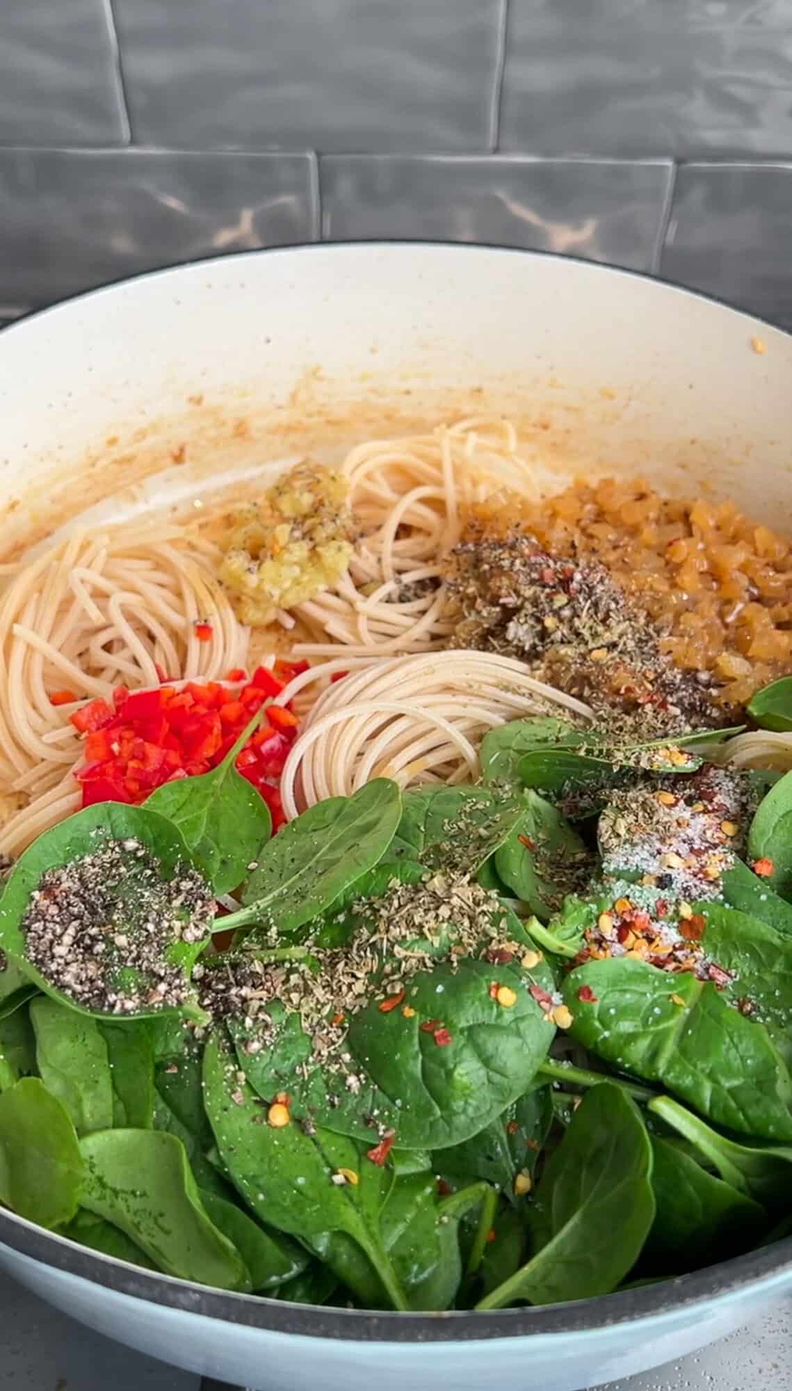 spinach and seasonings added to one pot chicken scampi