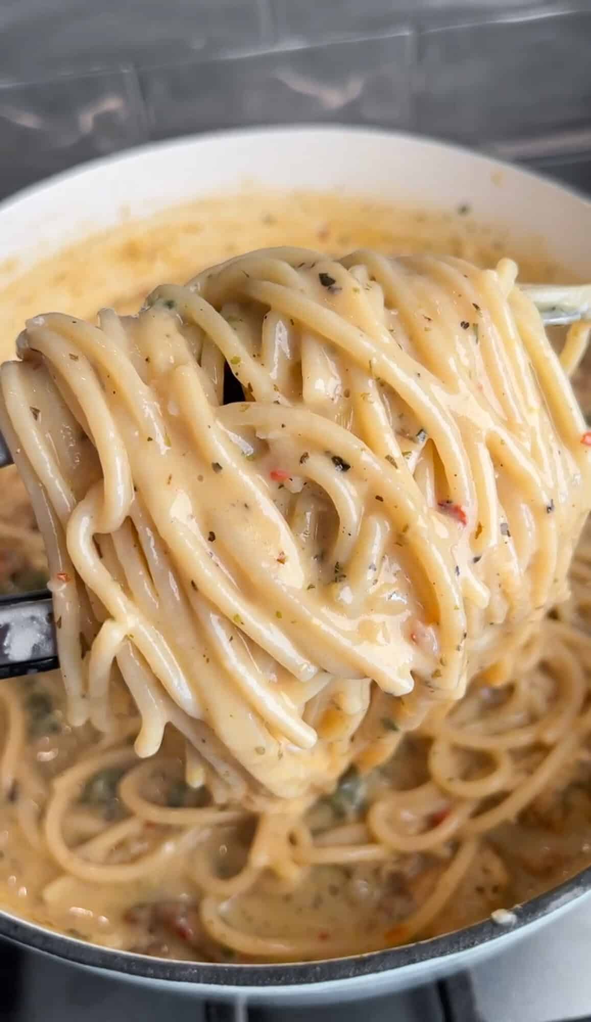 one-pot chicken scampi in a pan being tossed in pan sauce