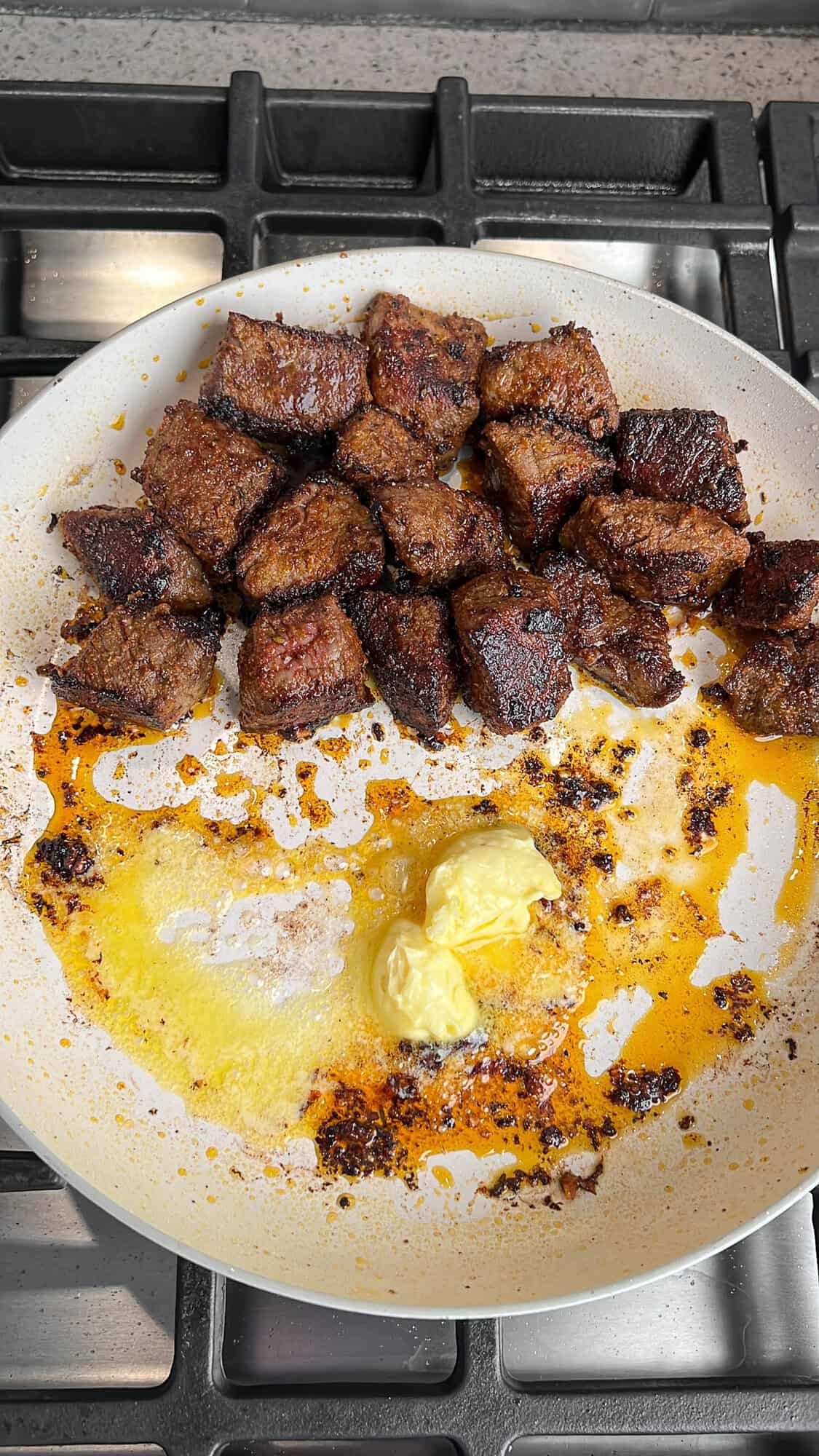 steak bites being tossed in garlic butter