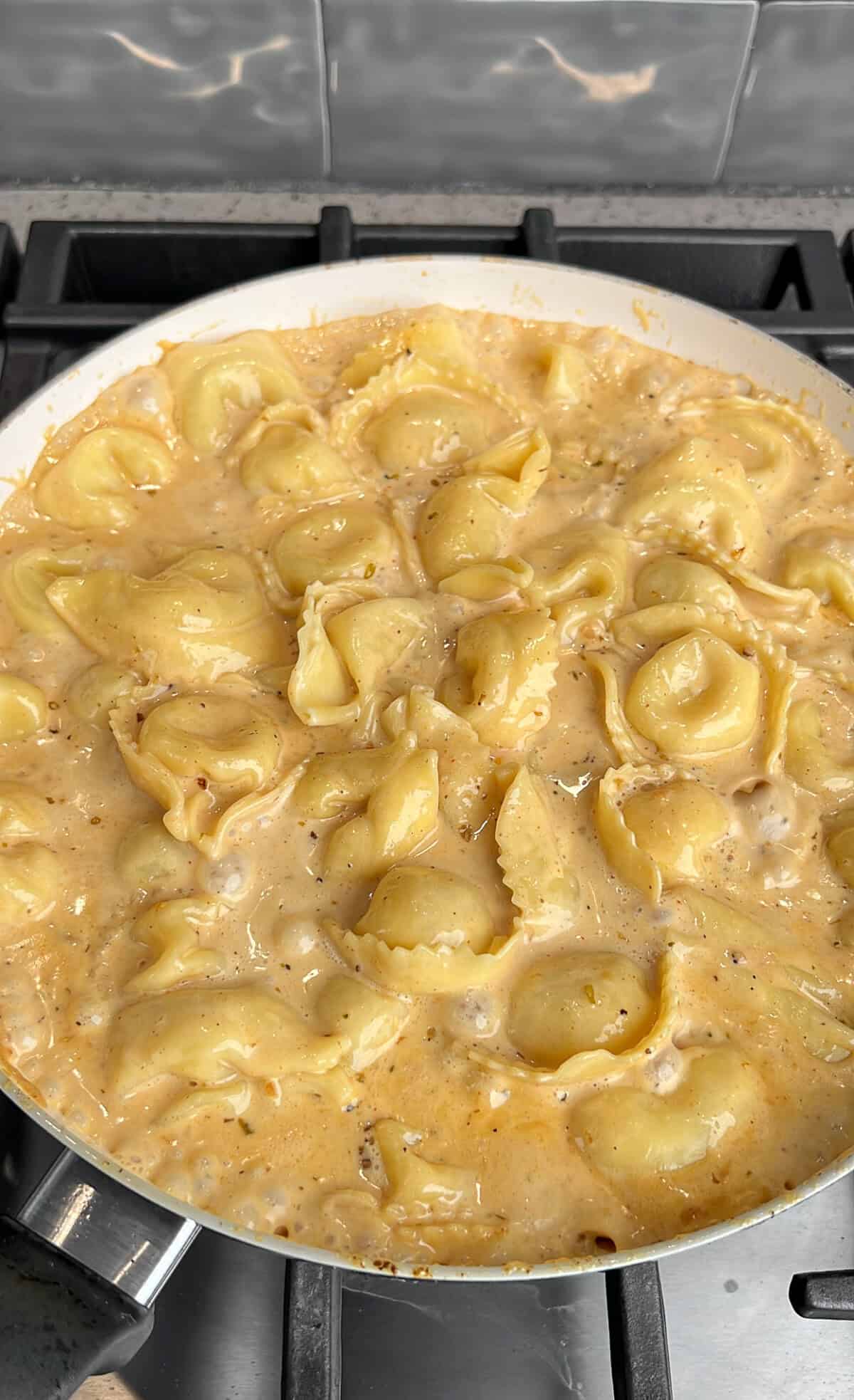 tortellini simmering in a pan