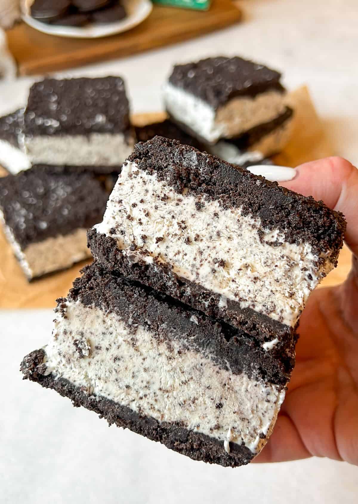 two oreo ice cream sandwiches being held in hand